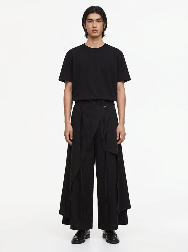 Men's Dark Cotton Hakama Pants in black, front view: the wrap panel buttons at the right hip over wide floor-length legs