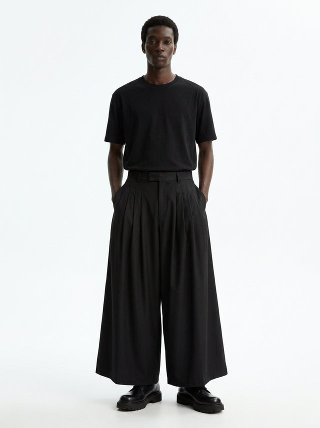 Men's Wide Pleated Japanese Hakama Pants in black, front view: four deep pleats each side and a very wide ankle-length leg
