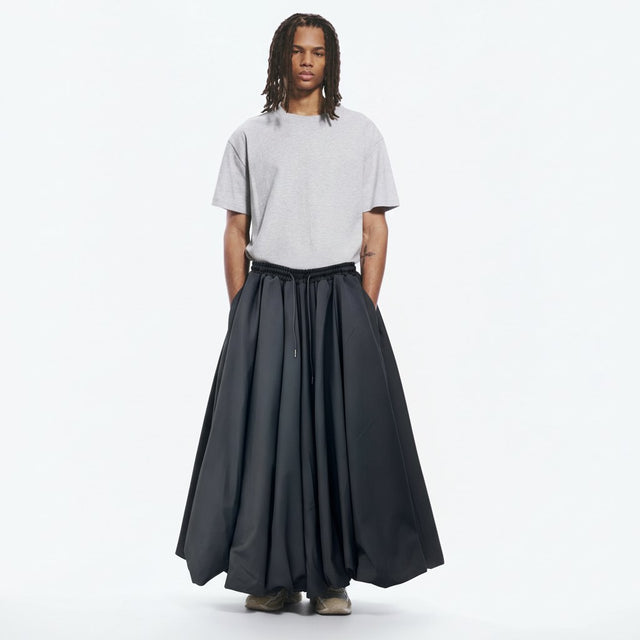 Crossover samue trousers on model in black, front view