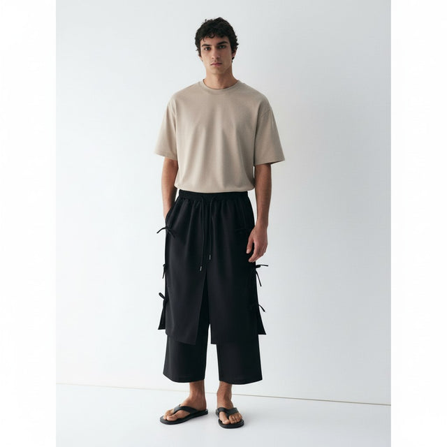 Tie-side wrap pants on model in black, front view