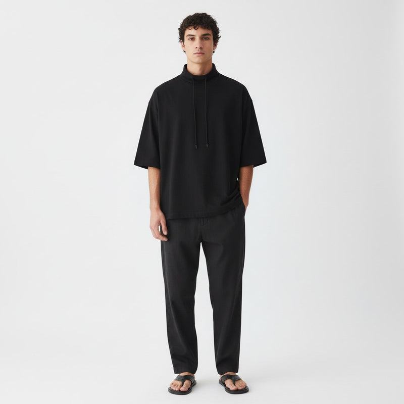Lyocell mock neck tee on model in black, front view