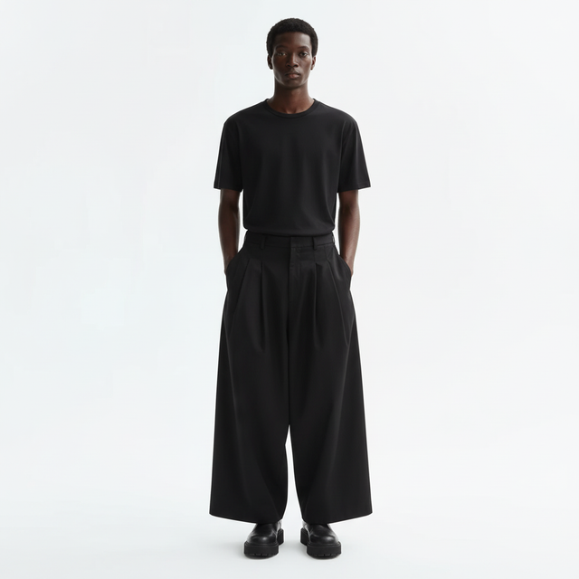 Wide pleated Japanese hakama on model in black, front view