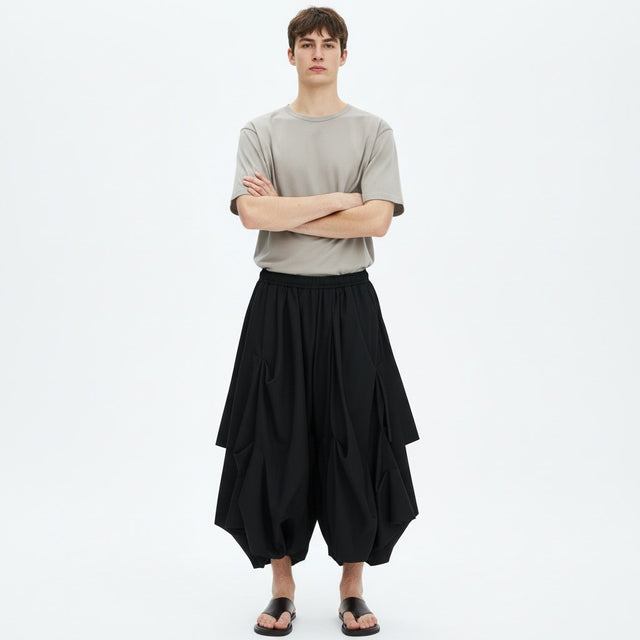 Bubble drape pants on model in black, front view