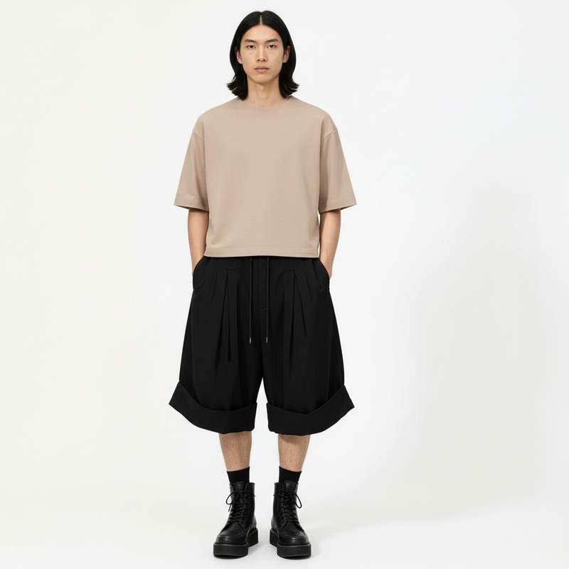 Pleated hakama shorts on model in black, front view