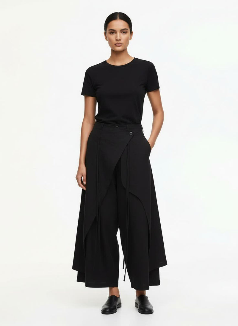 A woman wearing black hakama pants, front view