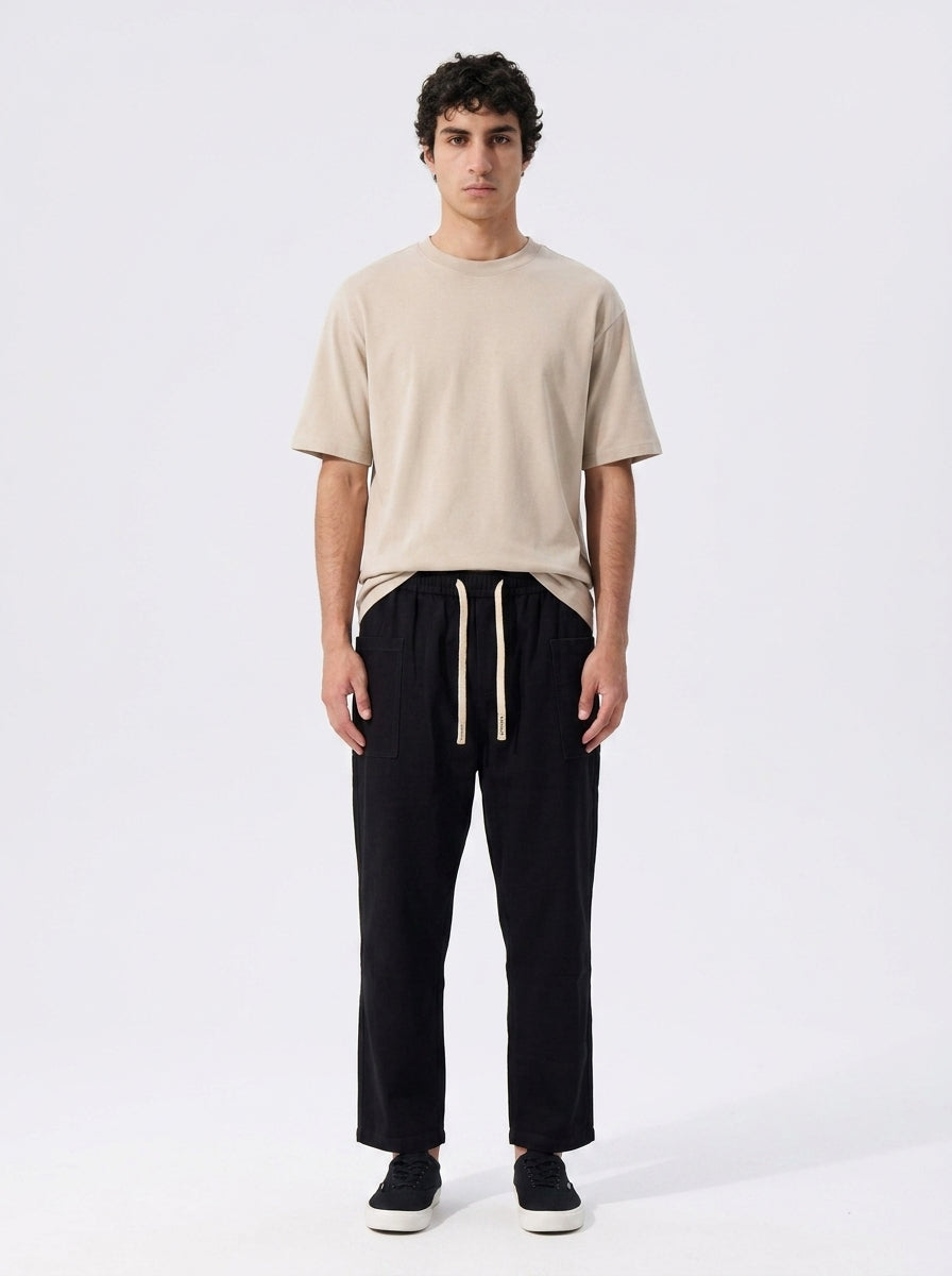 Loose cropped cotton work pants worn with a tee