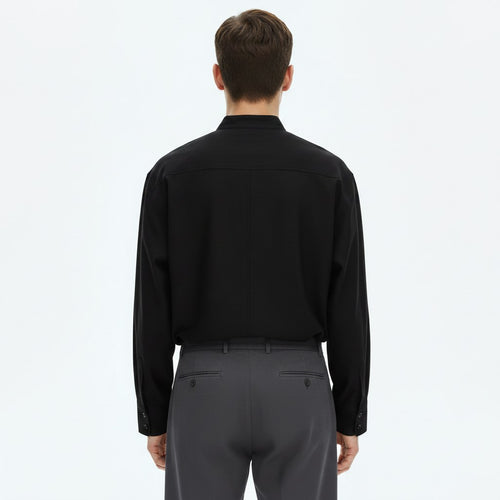 Asymmetrical stand collar shirt on model in black, back view