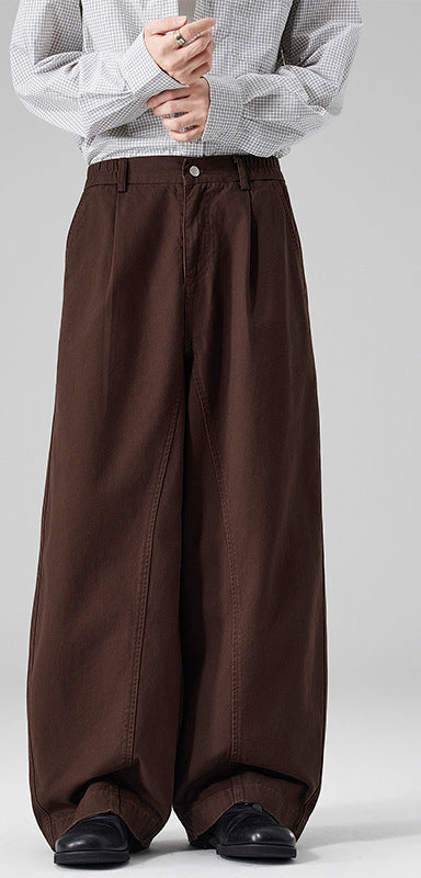 Men's wide leg barrel pants in brown, worn