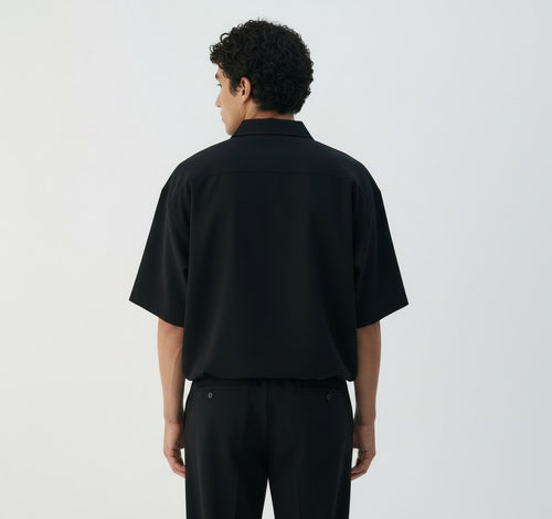 Boxy lyocell shirt on model in black, back view