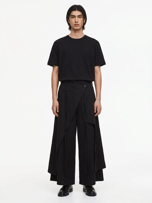 Men's Dark Cotton Hakama Pants in black, front view: the wrap panel buttons at the right hip over wide floor-length legs
