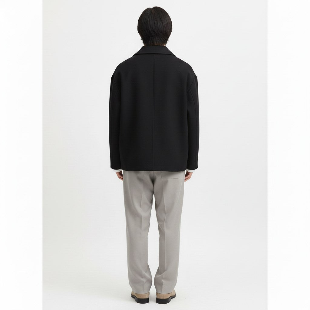 Cropped double breasted peacoat on model in black, back view