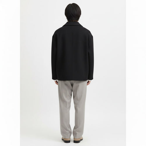 Cropped double breasted peacoat on model in black, back view