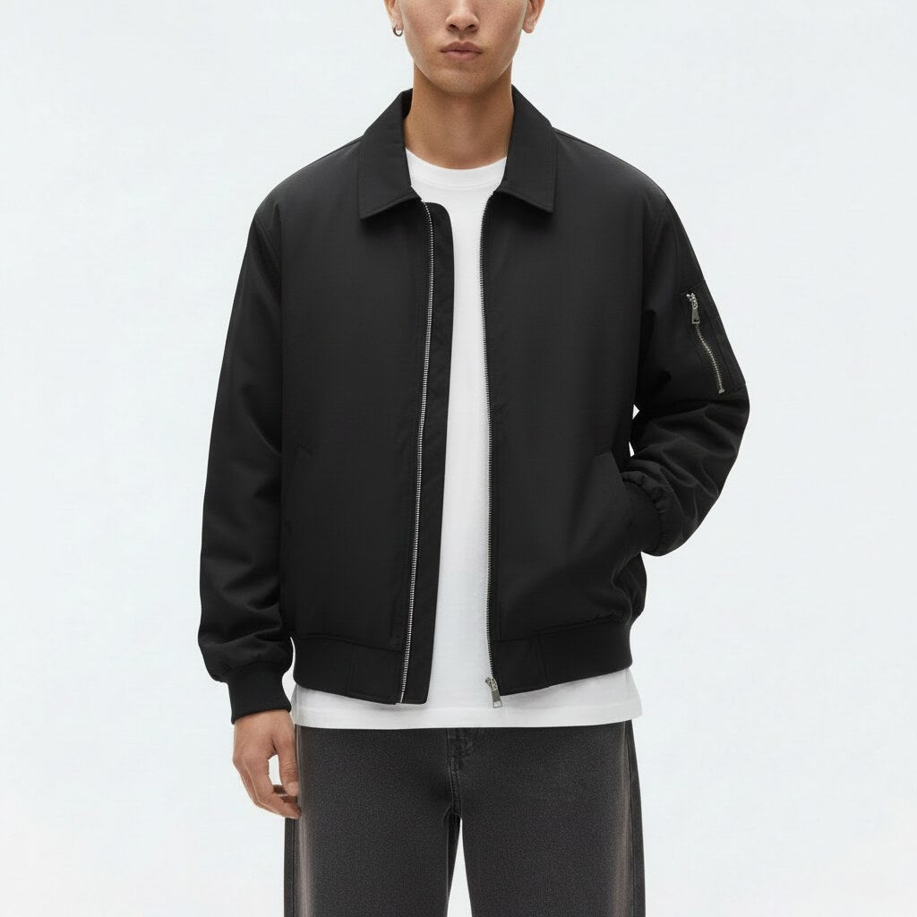 Drizzler Jacket on model in black, detail view of the collar, zip and rib-knit band