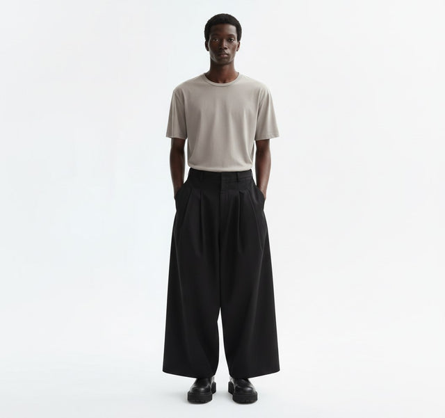 Wide pleated Japanese hakama on model in black, front view