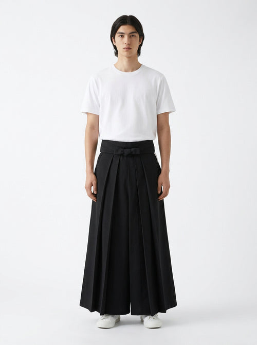 Cotton kendo hakama in black, front view on model, worn with a white t-shirt