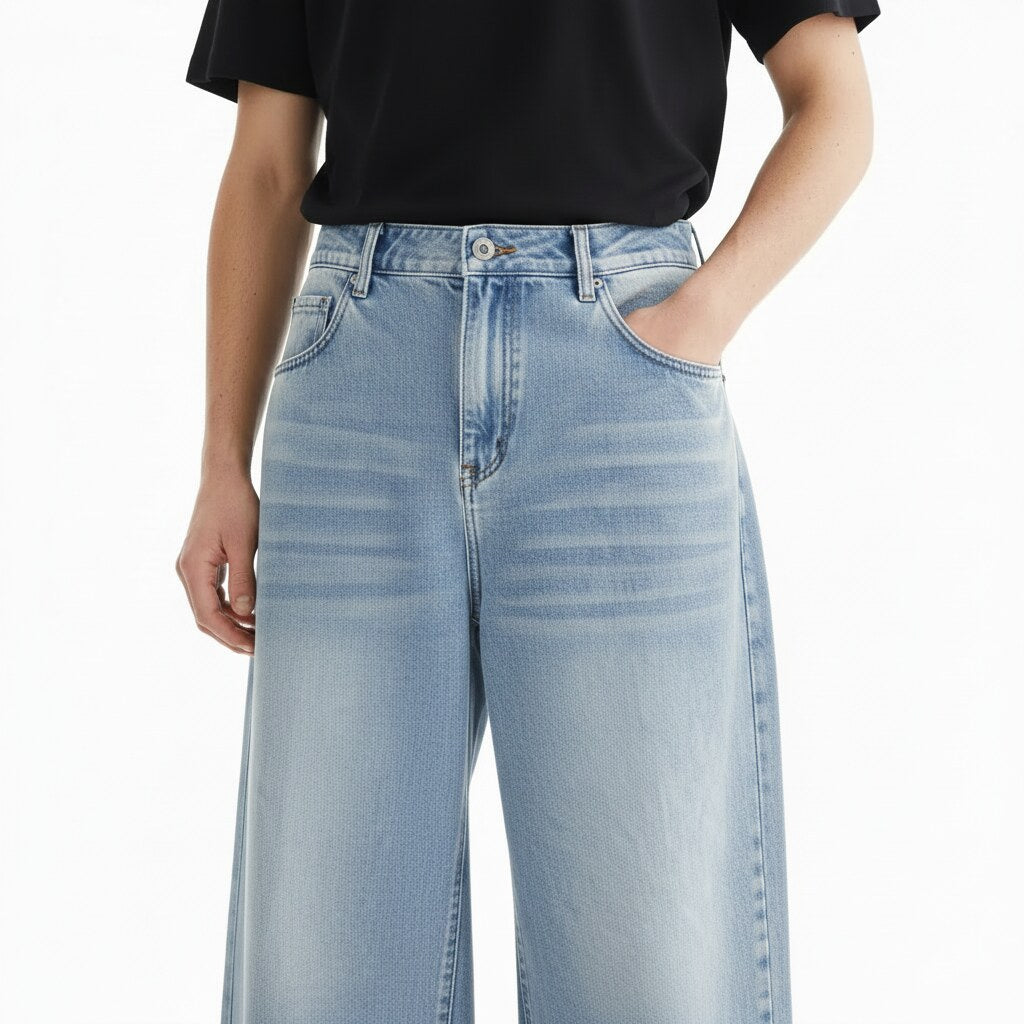 Light Wash Baggy Jeans on model, detail view of the faded wash and whiskering