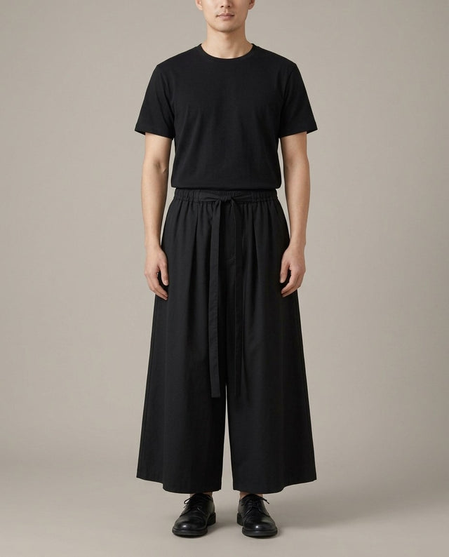 Men's lightweight hakama pants in black, front view: very wide leg and front tie belt