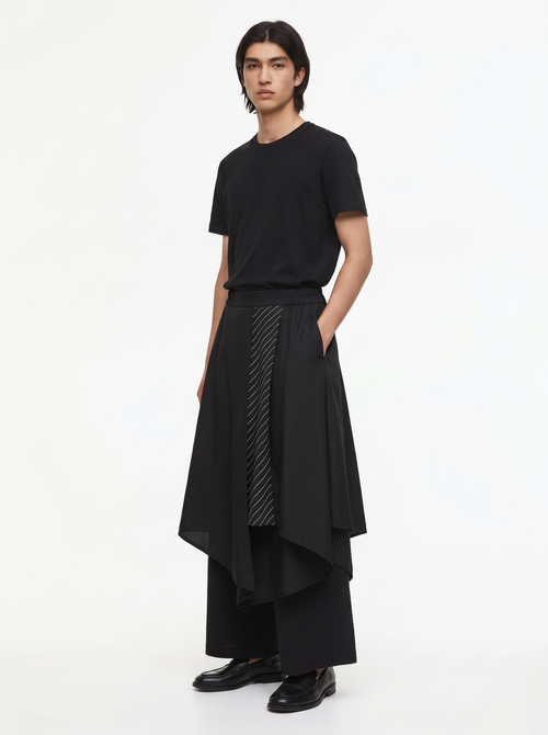 Double layered hakama pants in black, three-quarter view of the layered skirt overlay and wide legs