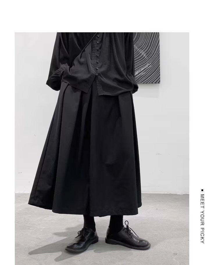 Men's japanese hakama pants, black pleated skirt panel, on model, front