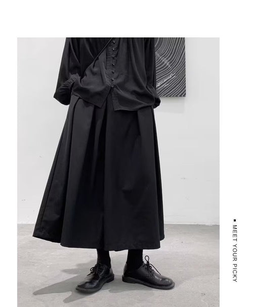 Men's japanese hakama pants, black pleated skirt panel, on model, front