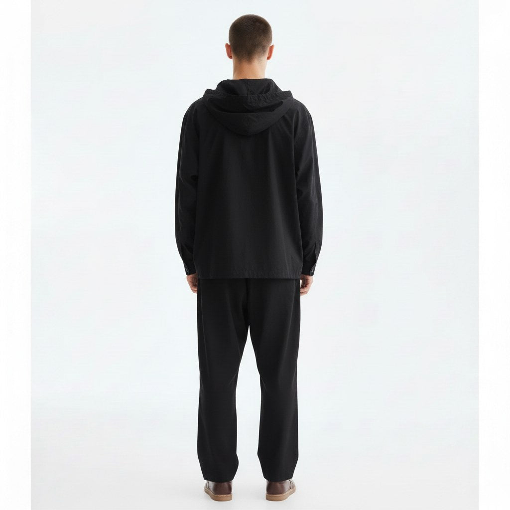 Hooded shirt jacket on model in black, back view
