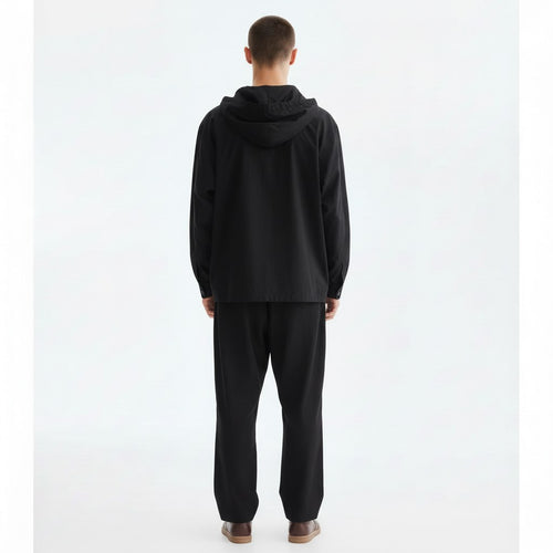 Hooded shirt jacket on model in black, back view