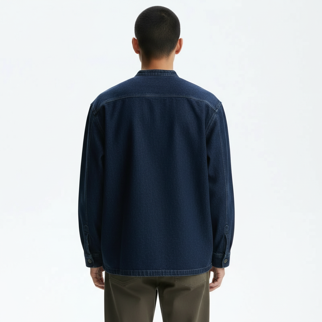 Collarless denim chore jacket in blue, back view on model