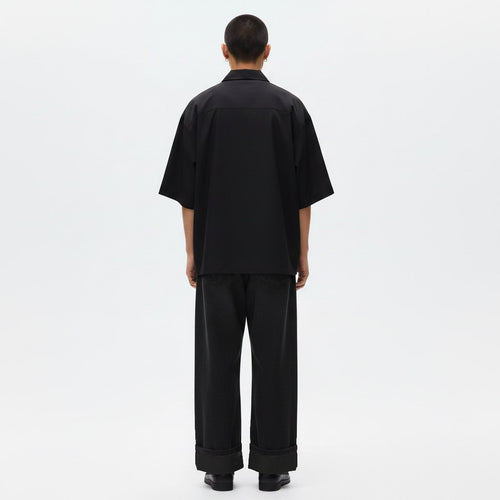 Japanese wide leg pants with belt on model in black, back view
