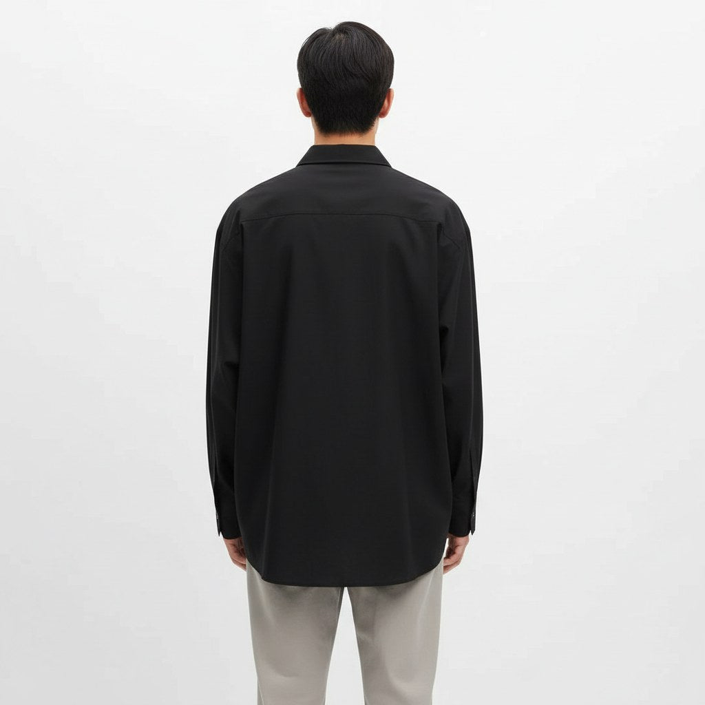 Oversized lyocell button up shirt in black, back view on model
