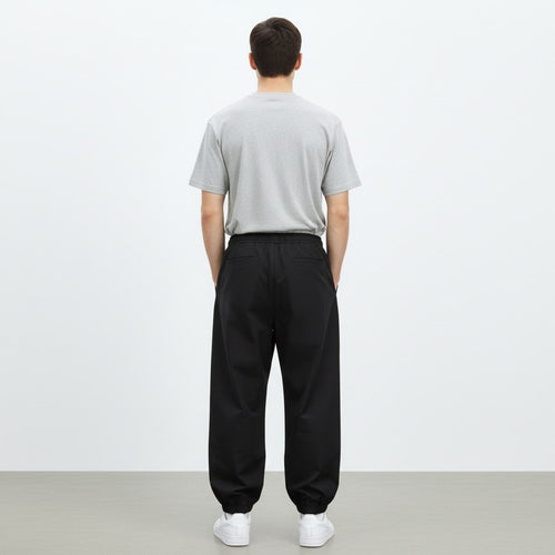 Wide lantern work pants in black, back view on model