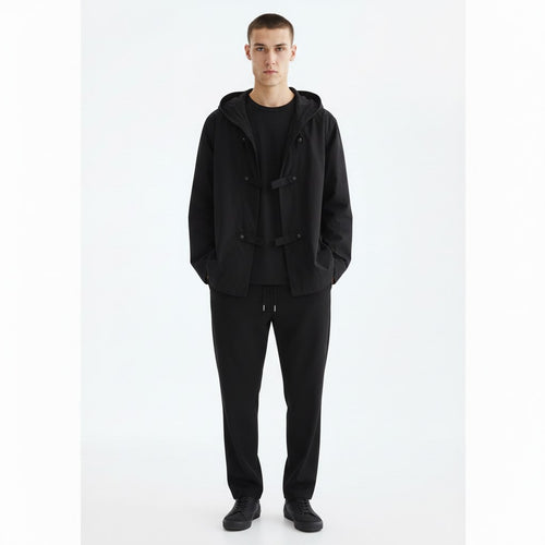 Hooded shirt jacket on model in black, front view