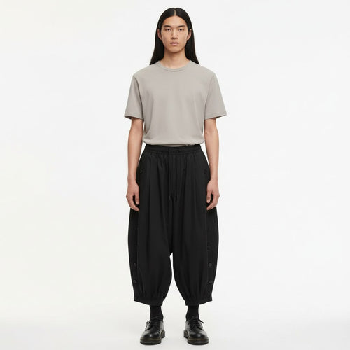 Men's Balloon Leg Tobi Trousers on model in black, front view