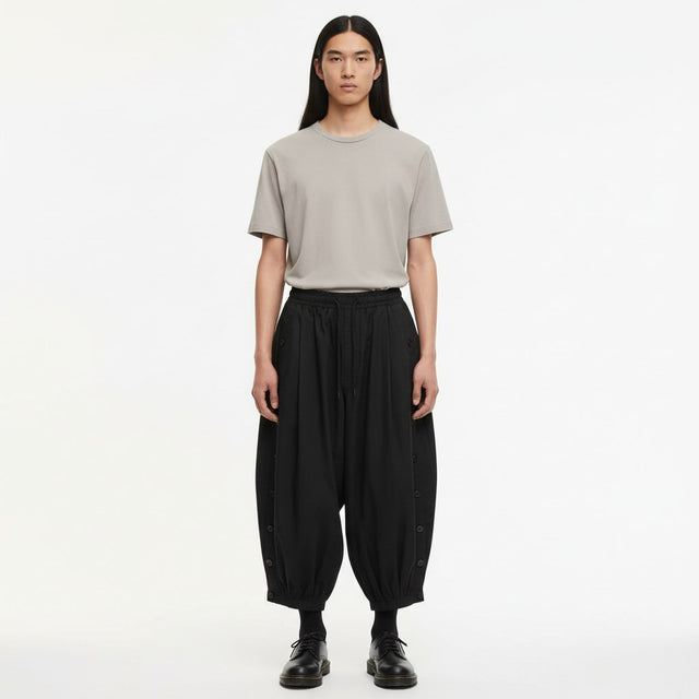 Balloon leg tobi trousers on model in black, front view