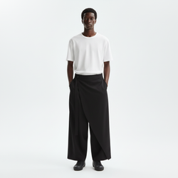 One leg skirt wrap pants on model in black, front view