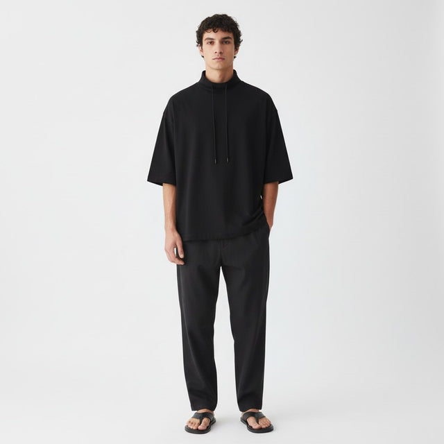 Lyocell mock neck tee on model in black, front view