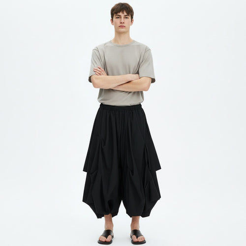 Bubble drape pants on model in black, front view