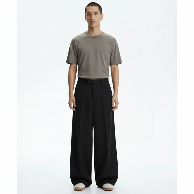 Wide pleated pants on model in black, front view
