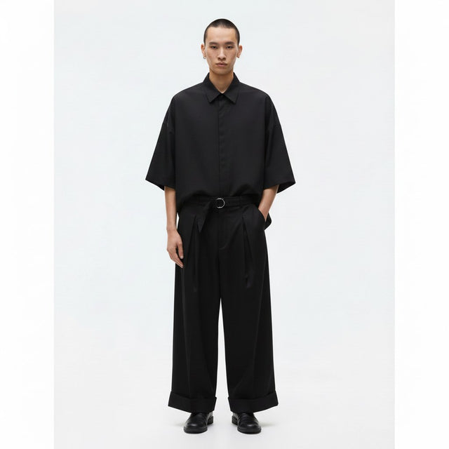Japanese wide leg pants with belt on model in black, front view