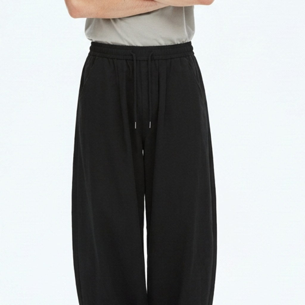 Wide lantern work pants on model, detail of the fabric and construction