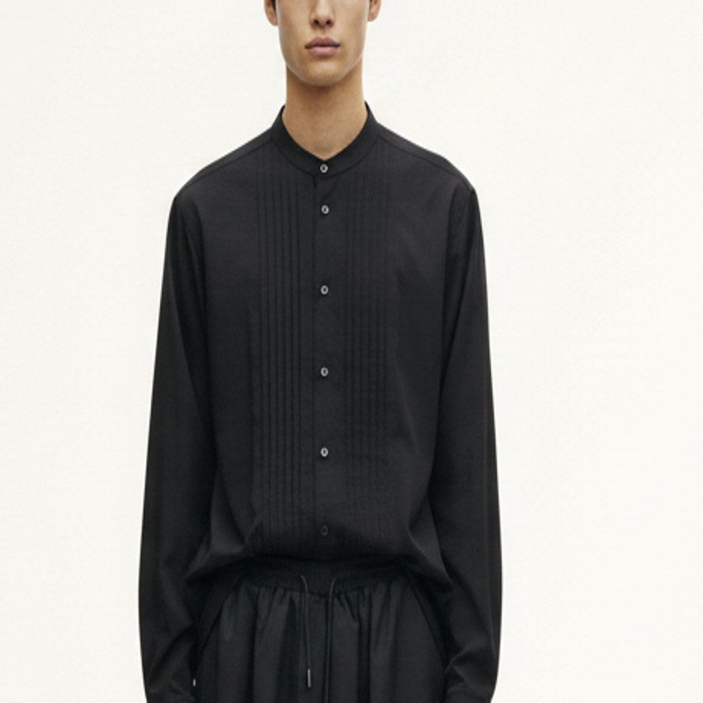 Pleated band collar shirt on model, detail of the fabric and construction