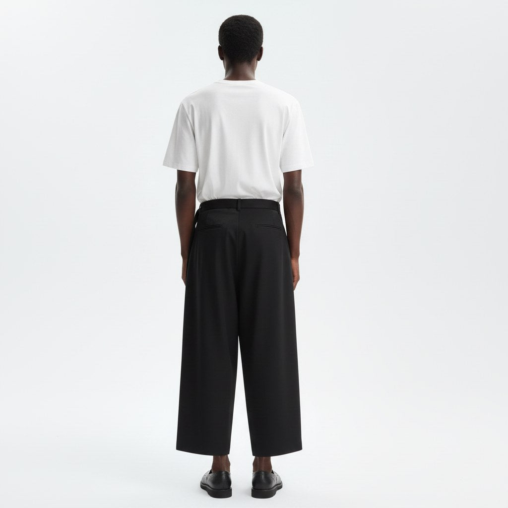 One leg skirt wrap pants on model in black, back view