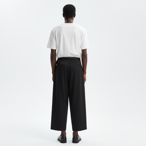 One leg skirt wrap pants on model in black, back view