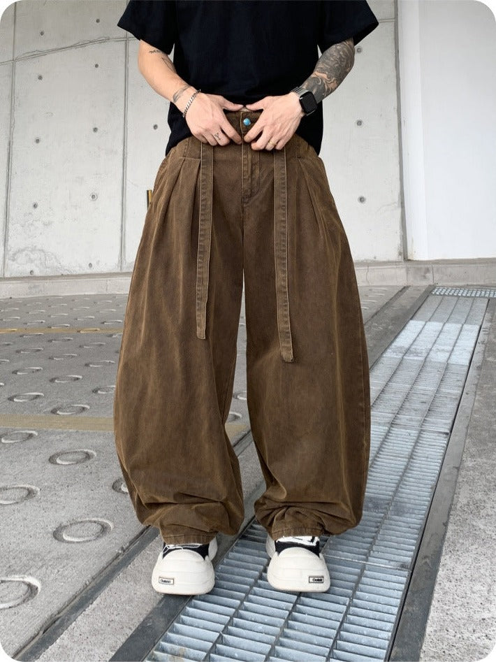 Brown pleated balloon pants worn with a black tee, front