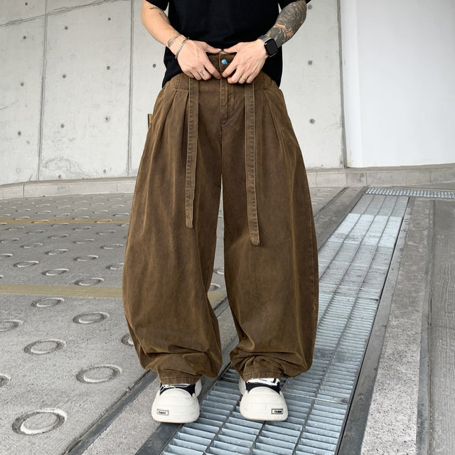 Men's pleated balloon pants in brown, front view with waist ties