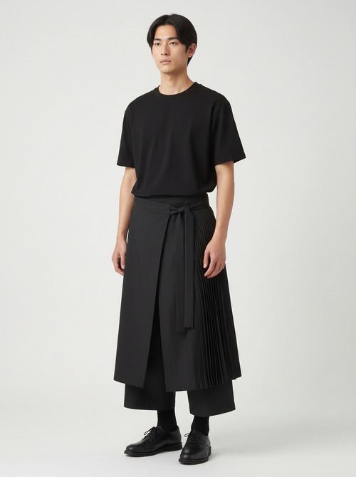Samurai hakama pants in black on a model, front view: wrap front, long waist tie and knife-pleated side panel