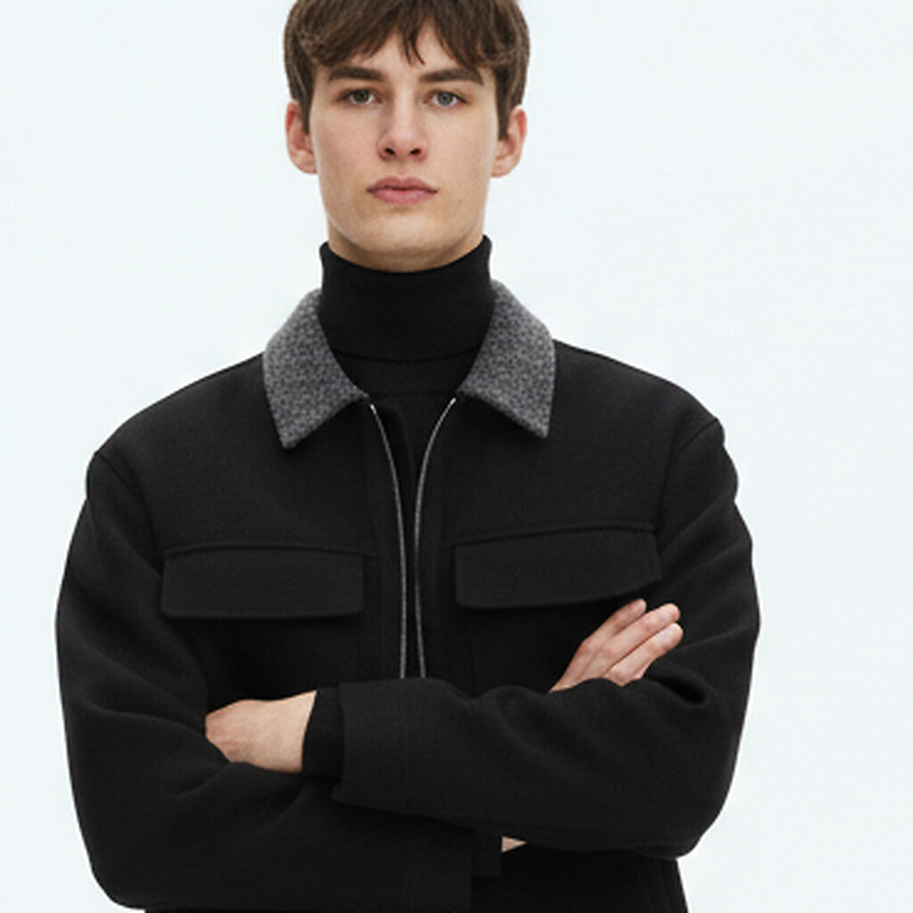 Wool Zip Jacket on model in black, detail view of the grey wool collar and chest pockets
